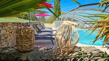 Outdoor pool, open 10:00 AM to 7:00 PM, pool umbrellas, pool loungers