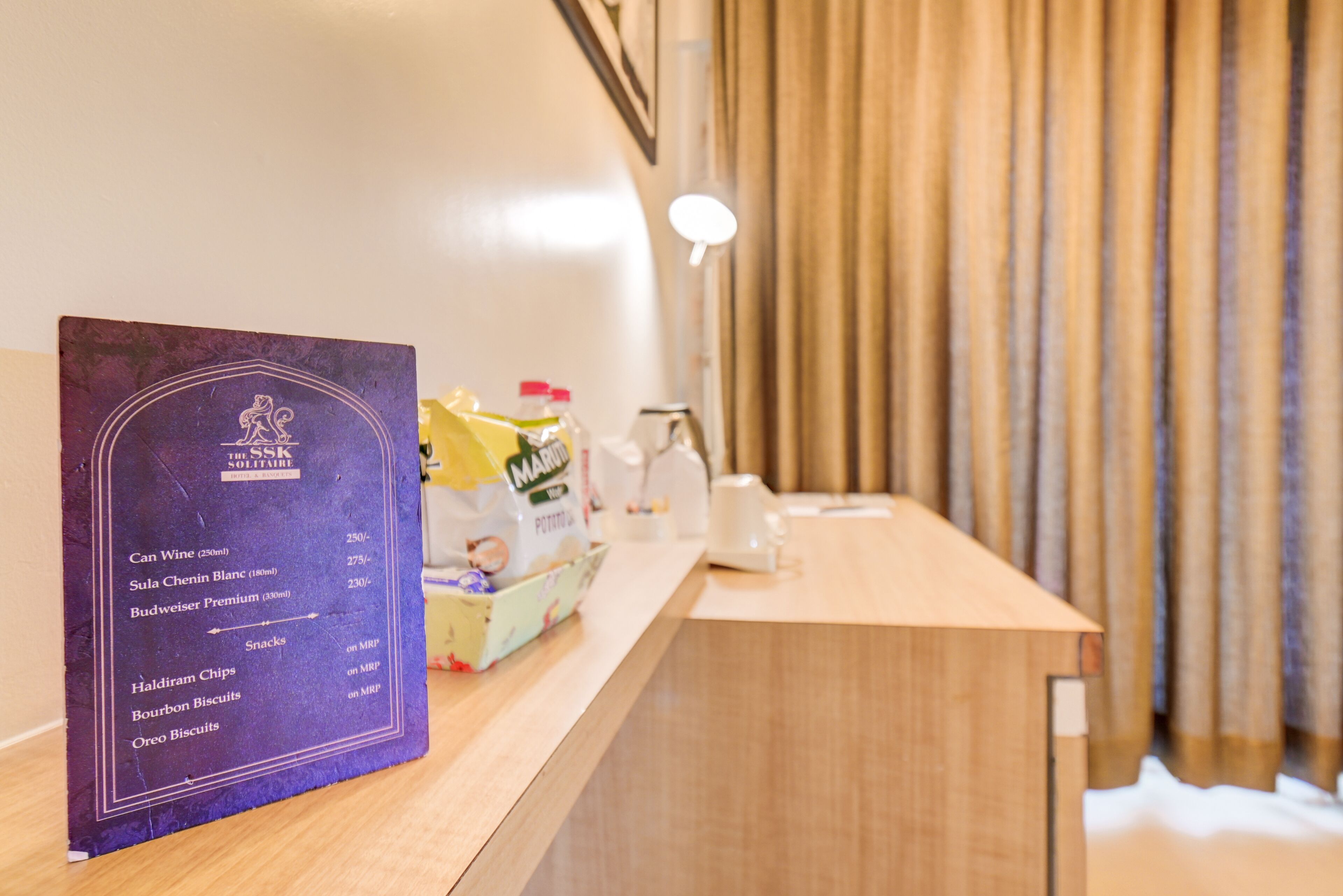 A hotel reception area with a menu board listing beverages and snacks.