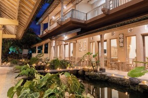 A multi-level outdoor area with a pool, plants, and seating. -  Uma Shanty Homestay (Karangasem)