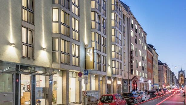 A multi-story hotel with a modern facade, large windows, and a visible sign for 'HAPIMAG'. - Hapimag Resort München (Munich)
