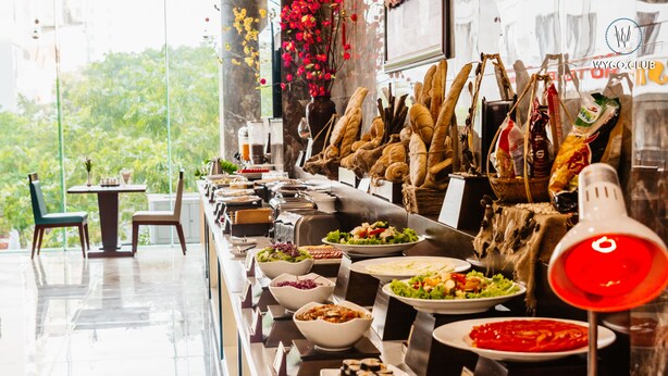 A buffet setup with various food items and a red lamp.