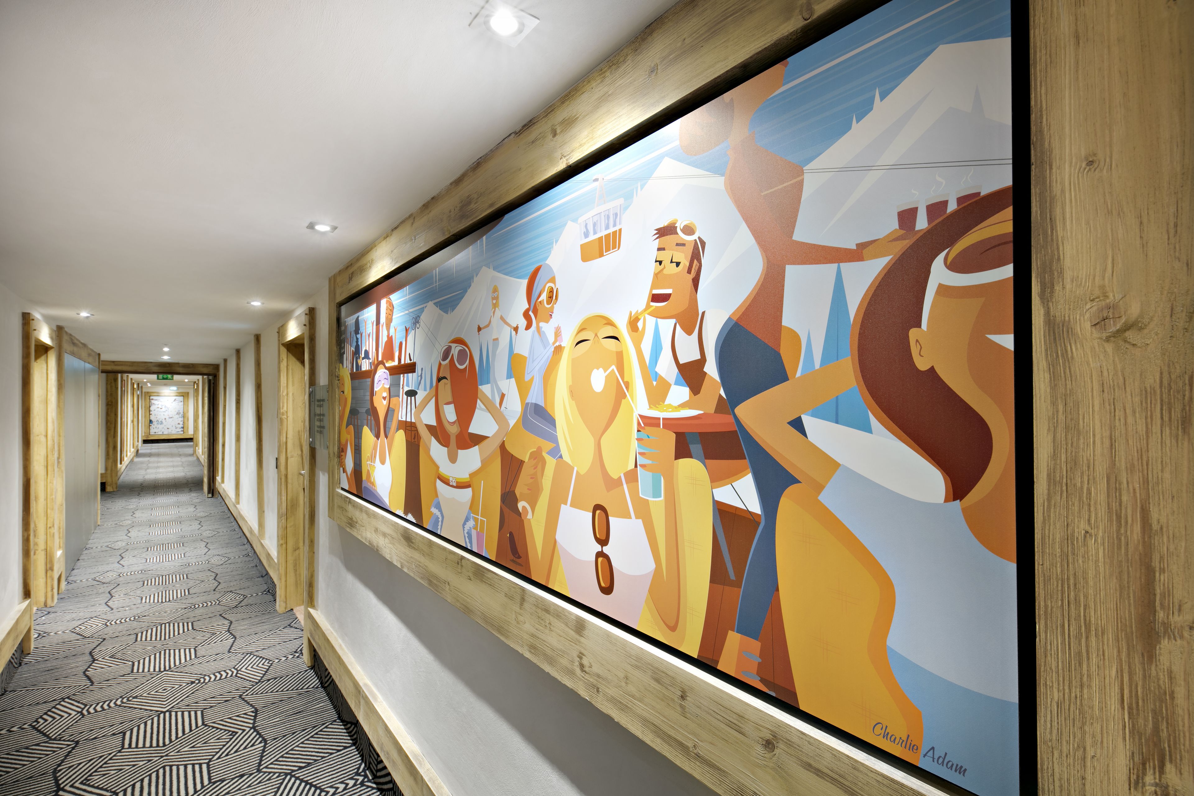 A hallway with a large mural, wooden paneling, and a patterned floor.