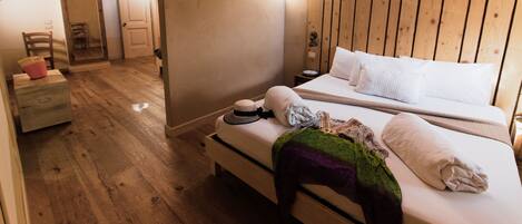 A cozy bedroom with a wooden headboard, a bedside table, and a nightstand.