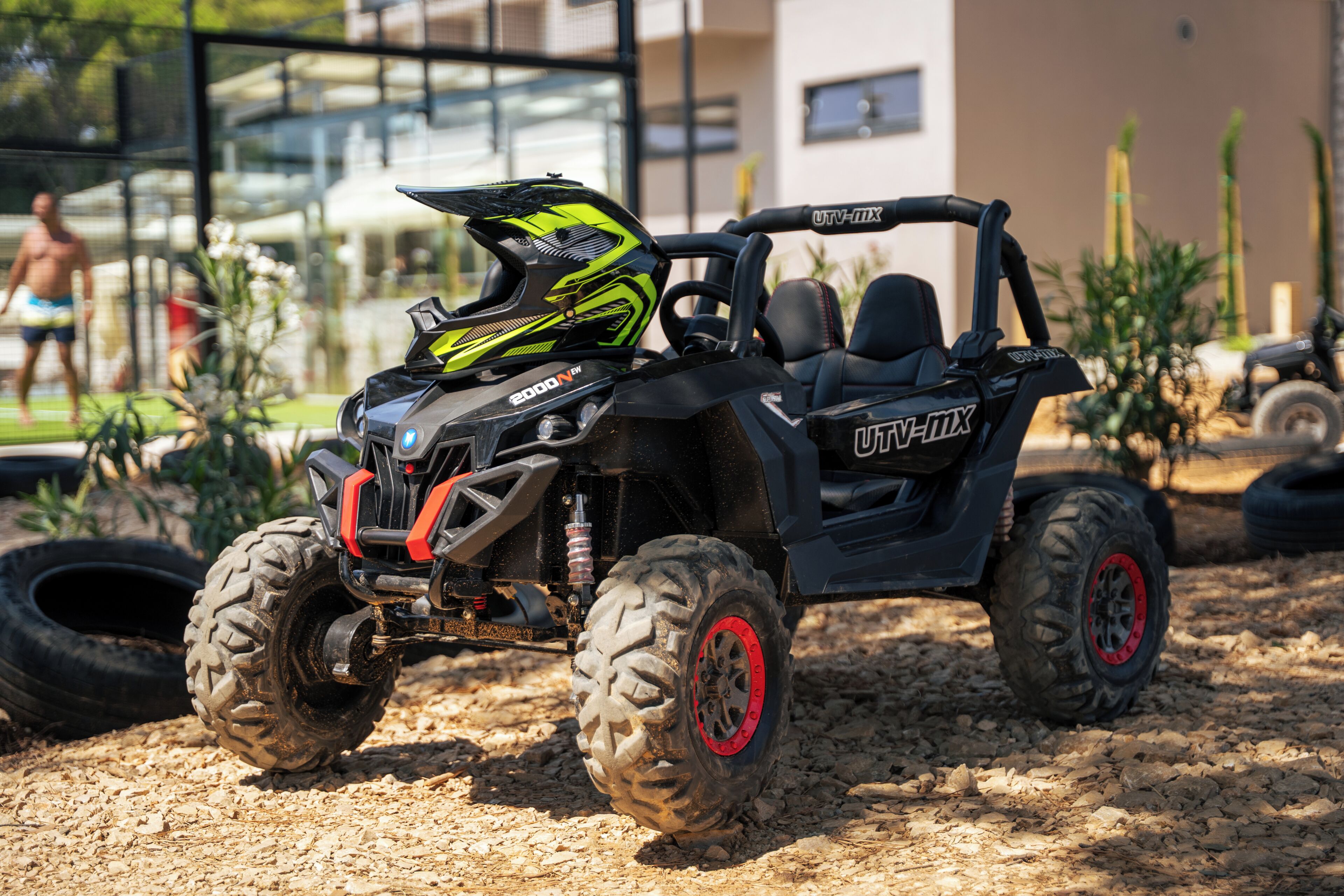A black off-road vehicle with a visible brand name and a protective helmet on the seat.