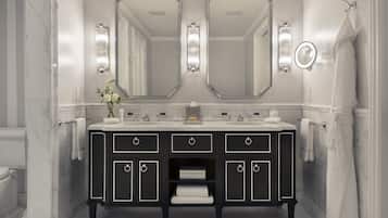 A bathroom with a black vanity, two large mirrors, and a towel rack.