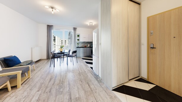 A modern apartment with a dining area, kitchen, and a large sliding door leading to a balcony. - Friendly Apartments - Kościelna (Poznan)