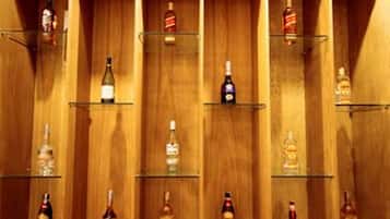 A row of wooden shelves with various bottles of liquor.