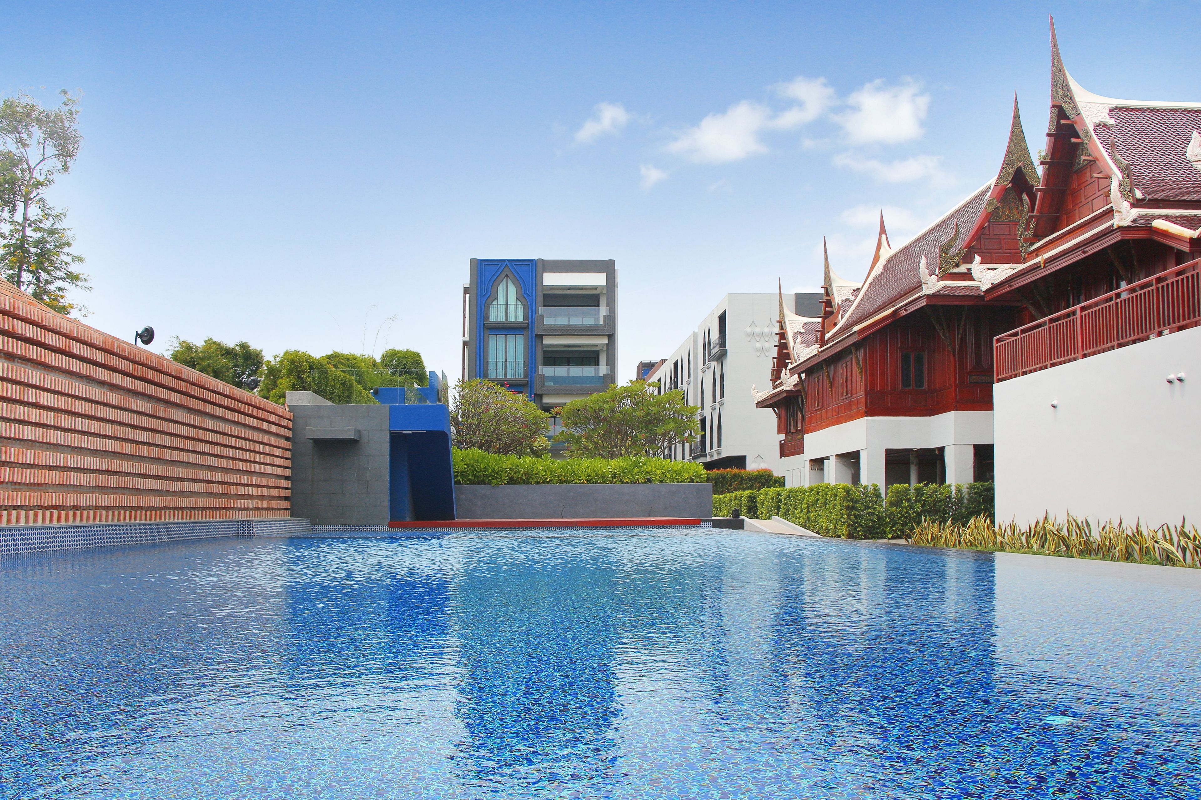 A swimming pool with a modern building in the background.