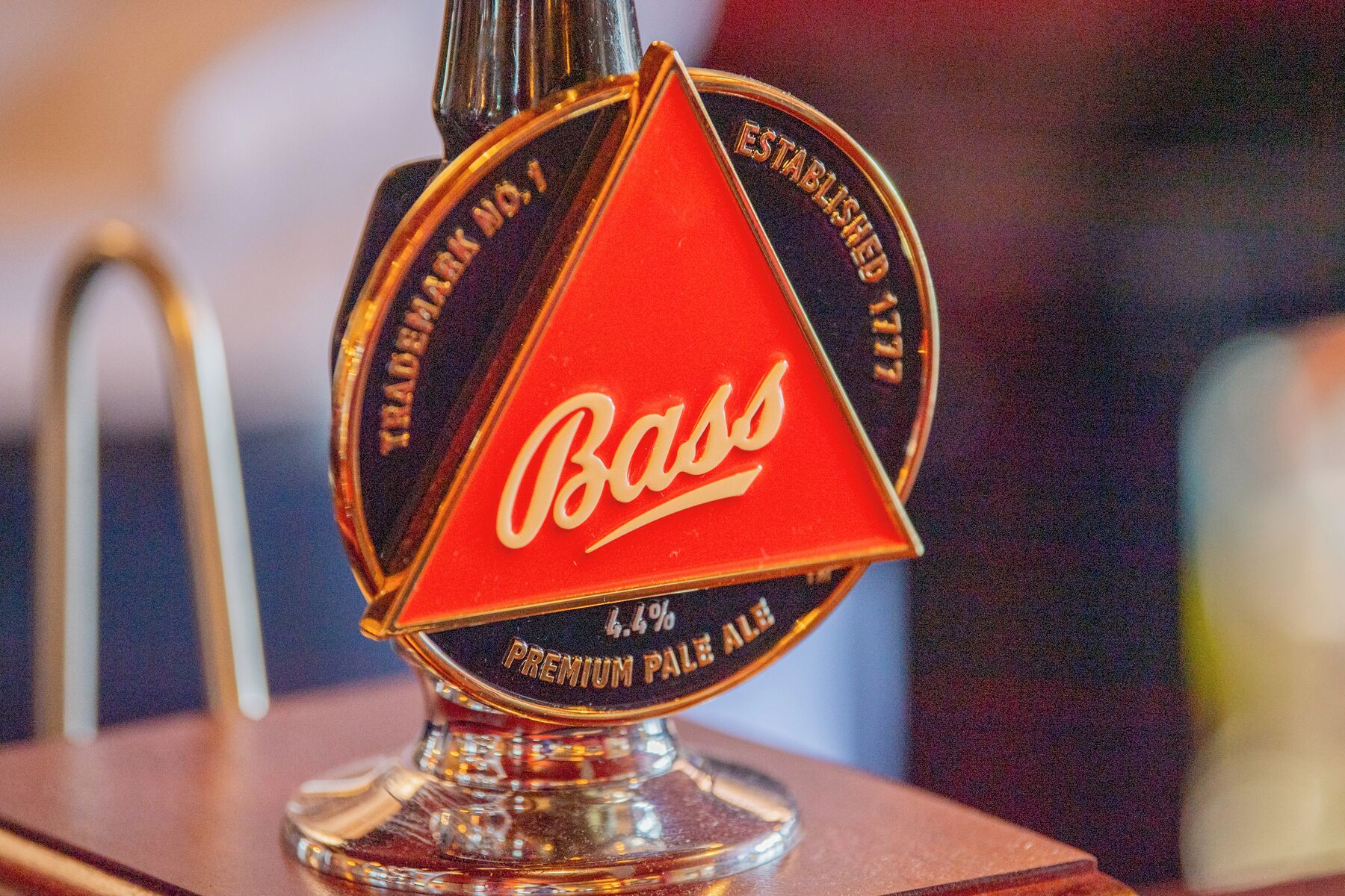 A beer tap with the label 'Bass' and 'Premium Pale Ale' on it.