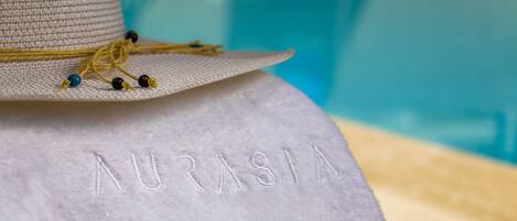 A white towel with the word "AURASIA" embroidered on it.