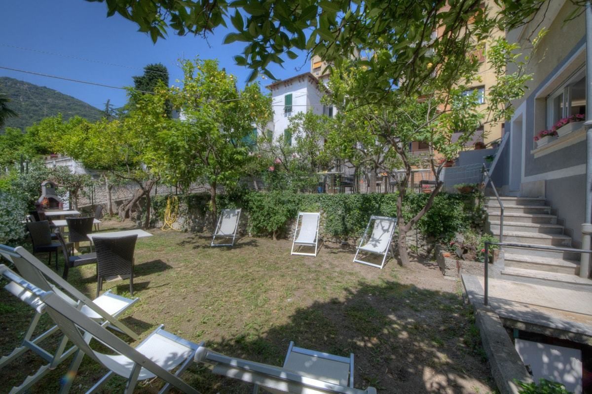 A courtyard with outdoor seating, a staircase, and a building in the background.