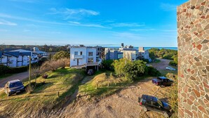 Un quartiere residenziale con case moderne, un sentiero sterrato e auto parcheggiate.