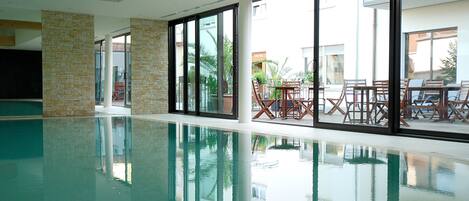 Indoor pool, open 7:30 AM to 9:00 PM, pool loungers