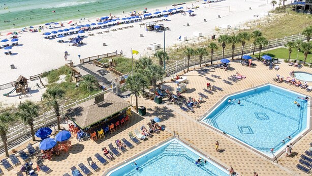 A beach resort with multiple swimming pools, sun loungers, and umbrellas. - Summit Beach Resort by H2O VR (Panama City Beach)