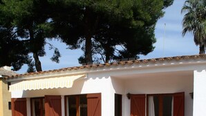 A two-story building with a stone facade, wooden balcony railings, and multiple windows with shutters. - Apartaments Margarita Sabina Pinell (Castell-Platja d'Aro)