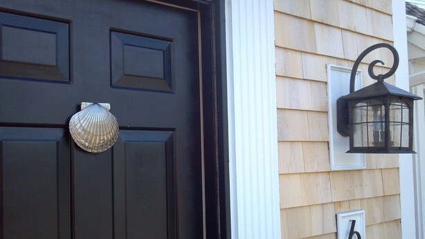 A dark brown door with a decorative shell and a white number '6' sign on a wooden house. - 5BR-Beautiful Chatham-Year Round-Sleeps up to ten (10) & 1 Mile to Town! (Chatham)