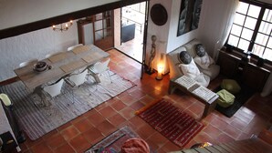 A spacious living area with a dining table, chairs, a sofa, and a fireplace. - Stunning Views Over The Bay Of Cannes (Fréjus)