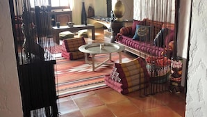 A spacious living room with a sofa set, a coffee table, and a patterned rug. - Stunning Views Over The Bay Of Cannes (Fréjus)