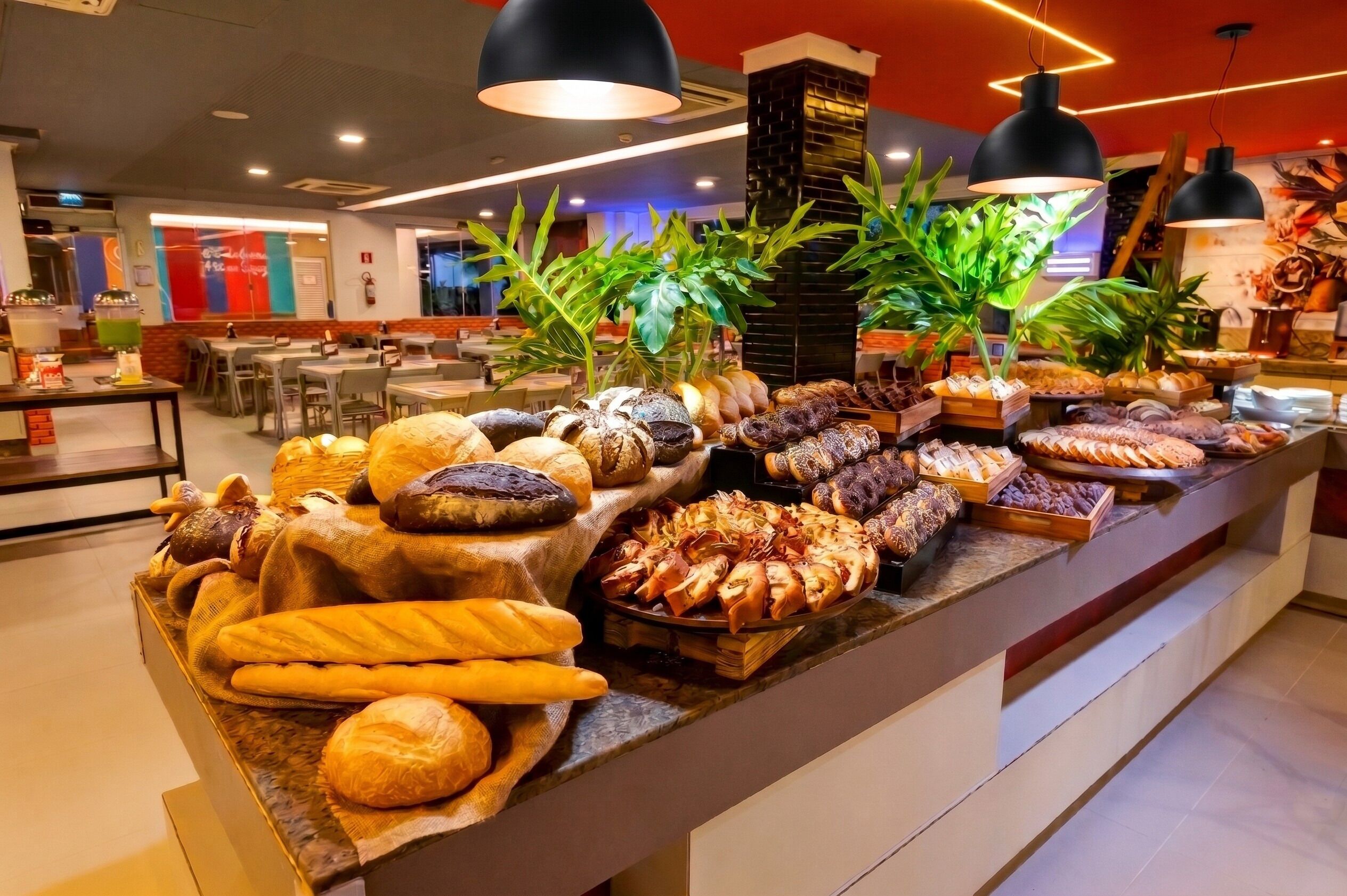 A buffet with various baked goods and pastries.