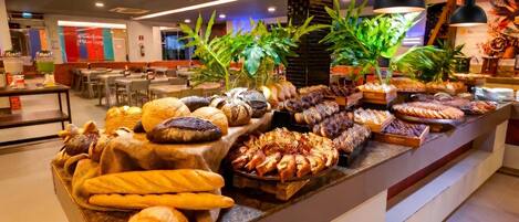 A buffet with various baked goods and pastries.