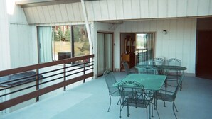 A covered outdoor patio with a table and chairs, a railing, and a view of the surrounding area. - Gondola Square, only 60 feet to the gondola. Best location. (Steamboat Springs)
