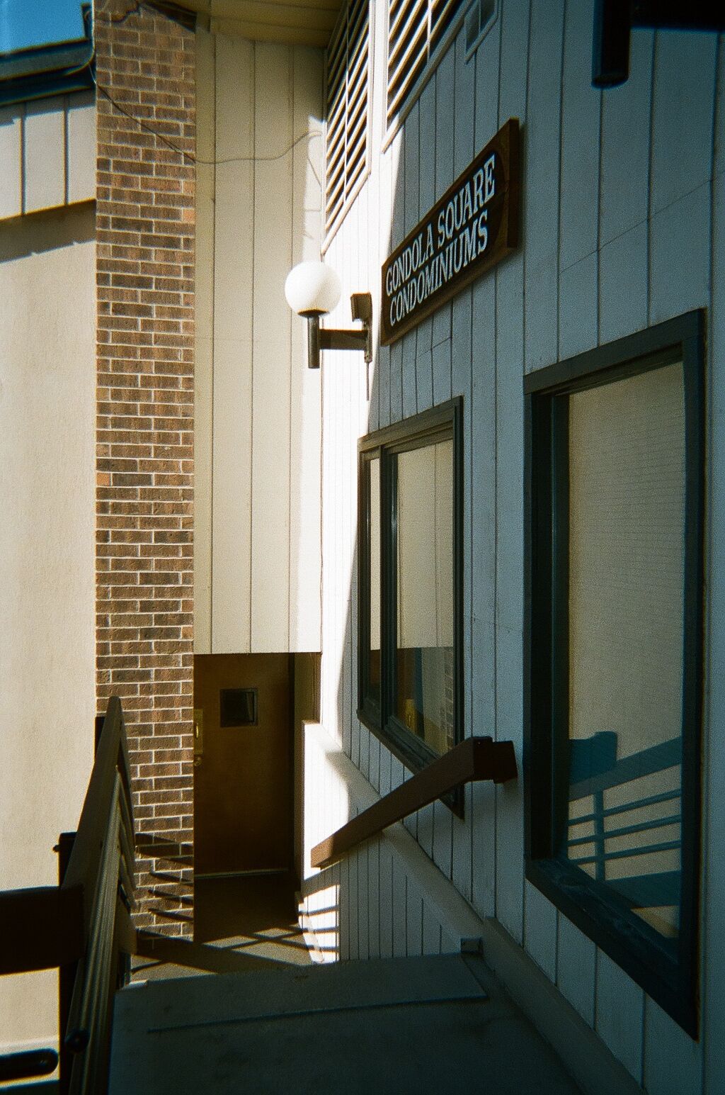 A building entrance with a sign reading "Gondola Square Condominiums."