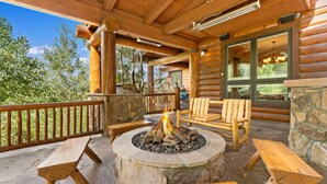 A wooden deck with a stone fire pit, wooden benches, and a stone wall. - Nearby River Run and the Gondola, Covered Patio w/Hot Tub, Media/Game Room (Keystone)