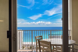 A balcony with a view of the ocean, a table, and chairs. - Ariel Dunes I 2109 - Amazing Gulf Views, Heated Community Pool, Exercise Room! (Miramar Beach)