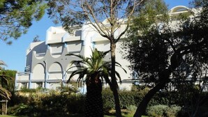 A building with a modern architectural style, featuring a symmetrical facade with arched windows and a central dome.