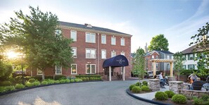 A brick building with a curved awning labeled 'The Sire Hotel.' - The Sire Hotel Lexington,tapestry Collection by Hi (Lexington)