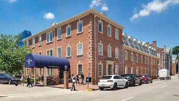 A brick building with a blue awning labeled "The Sire Hotel."
