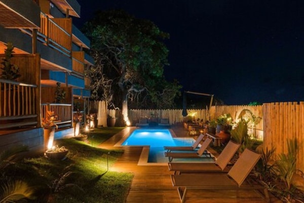 Una piscina al aire libre, sillones reclinables de piscina