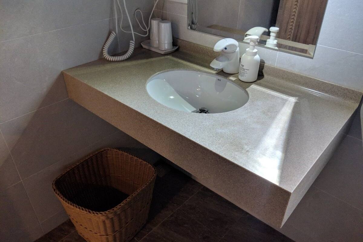 deluxe quadruple room, 2 double beds, garden view | bathroom | shower, hair dryer, slippers, towels