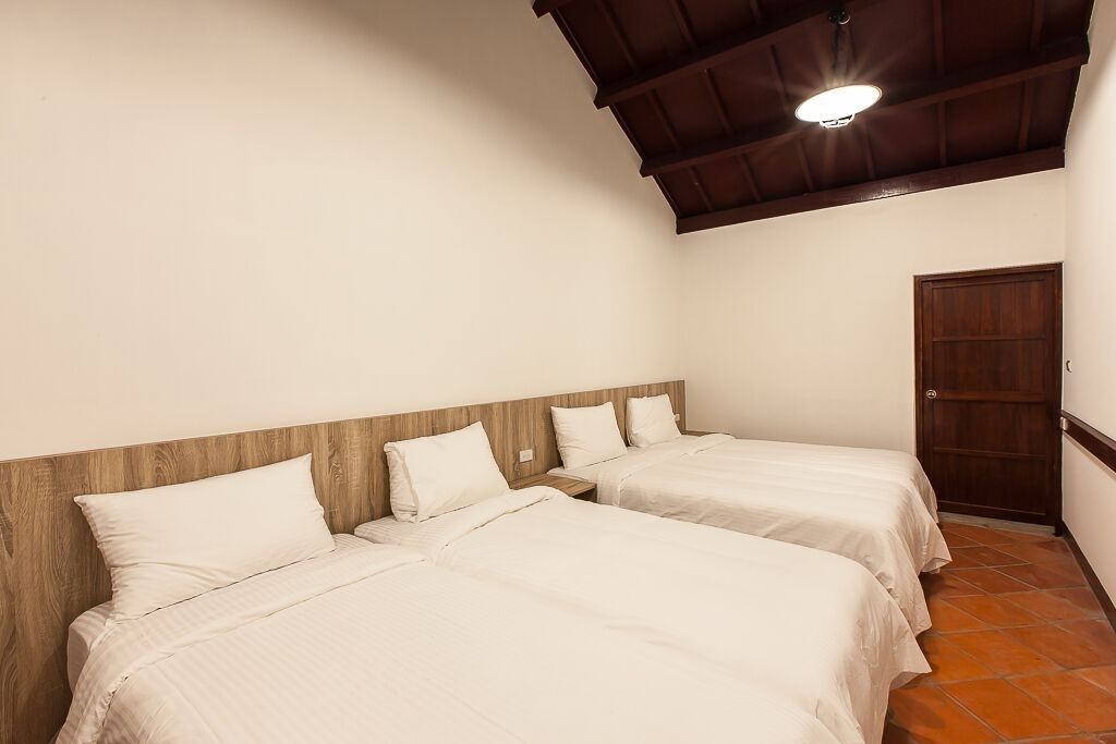 deluxe quadruple room, 2 double beds, garden view | minibar, desk, blackout curtains, soundproofing