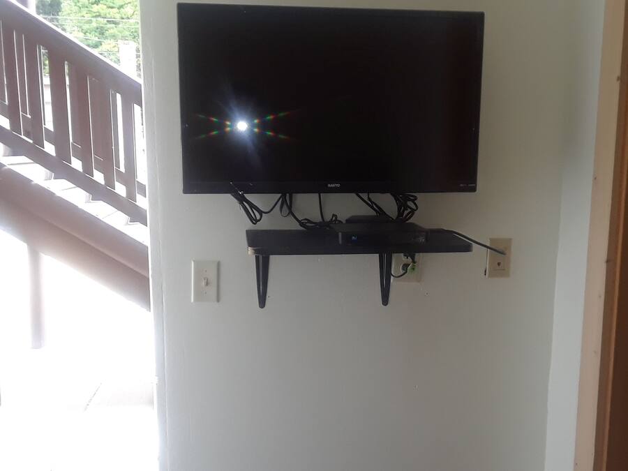 Una TV a schermo piatto montata a parete, con sistema di gestione dei cavi.