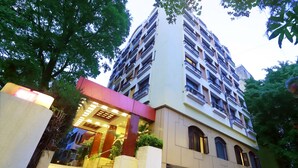 A multi-story hotel with a modern facade, large windows, and a well-lit entrance area. - Kohinoor Executive (Pune)