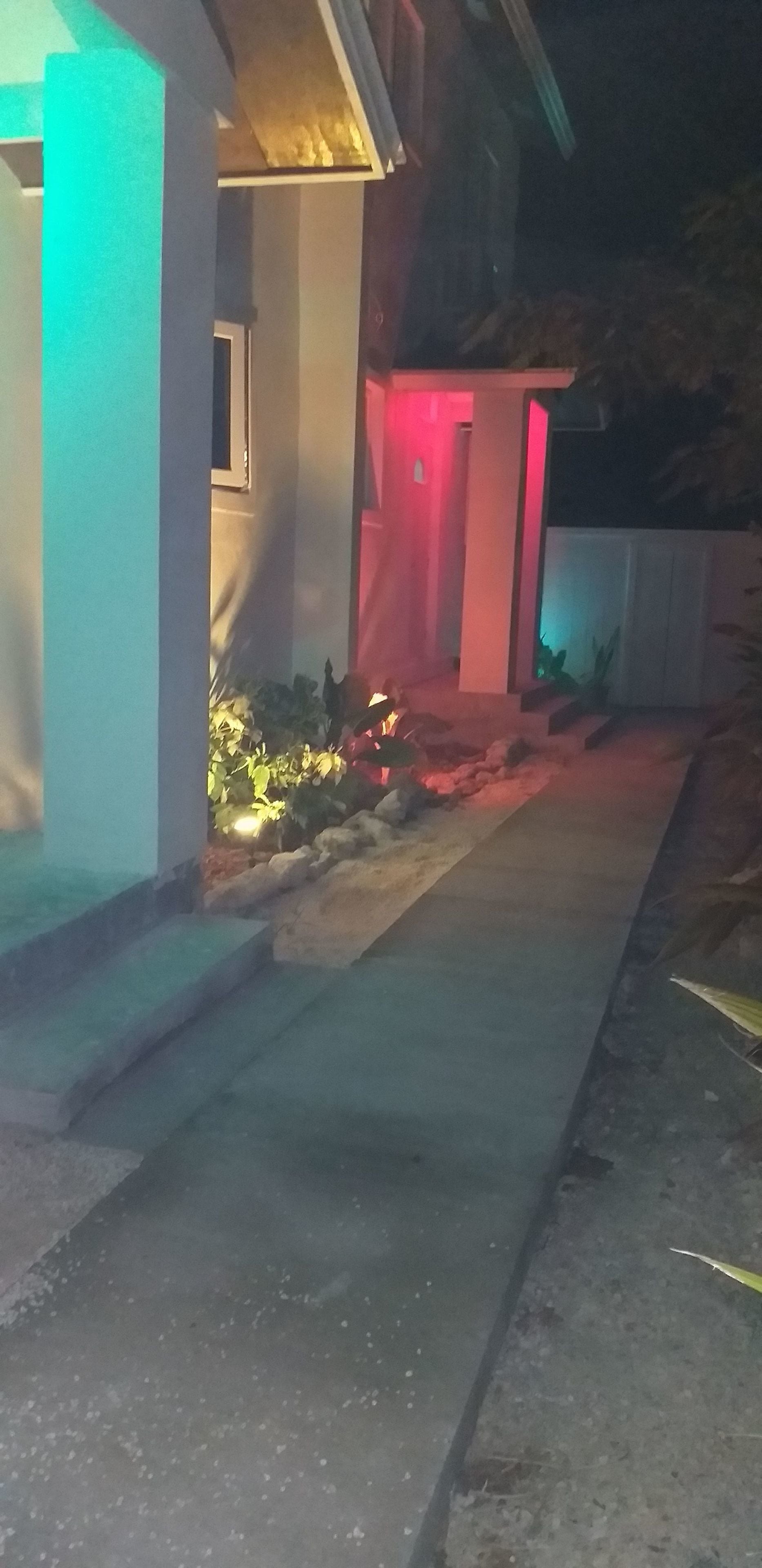 A residential house with a visible front porch, steps leading to the entrance, and a pathway.