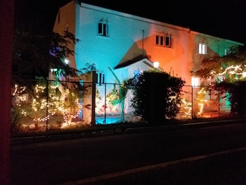 Front of property - evening/night at Bell At The Airport Suites - Adults Only