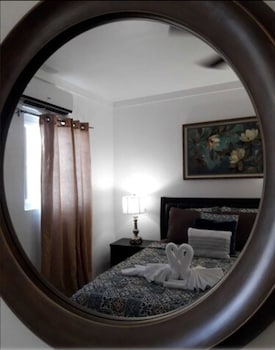 Traditional Suite | Minibar, desk, laptop workspace, iron/ironing board at Bell At The Airport Suites - Adults Only