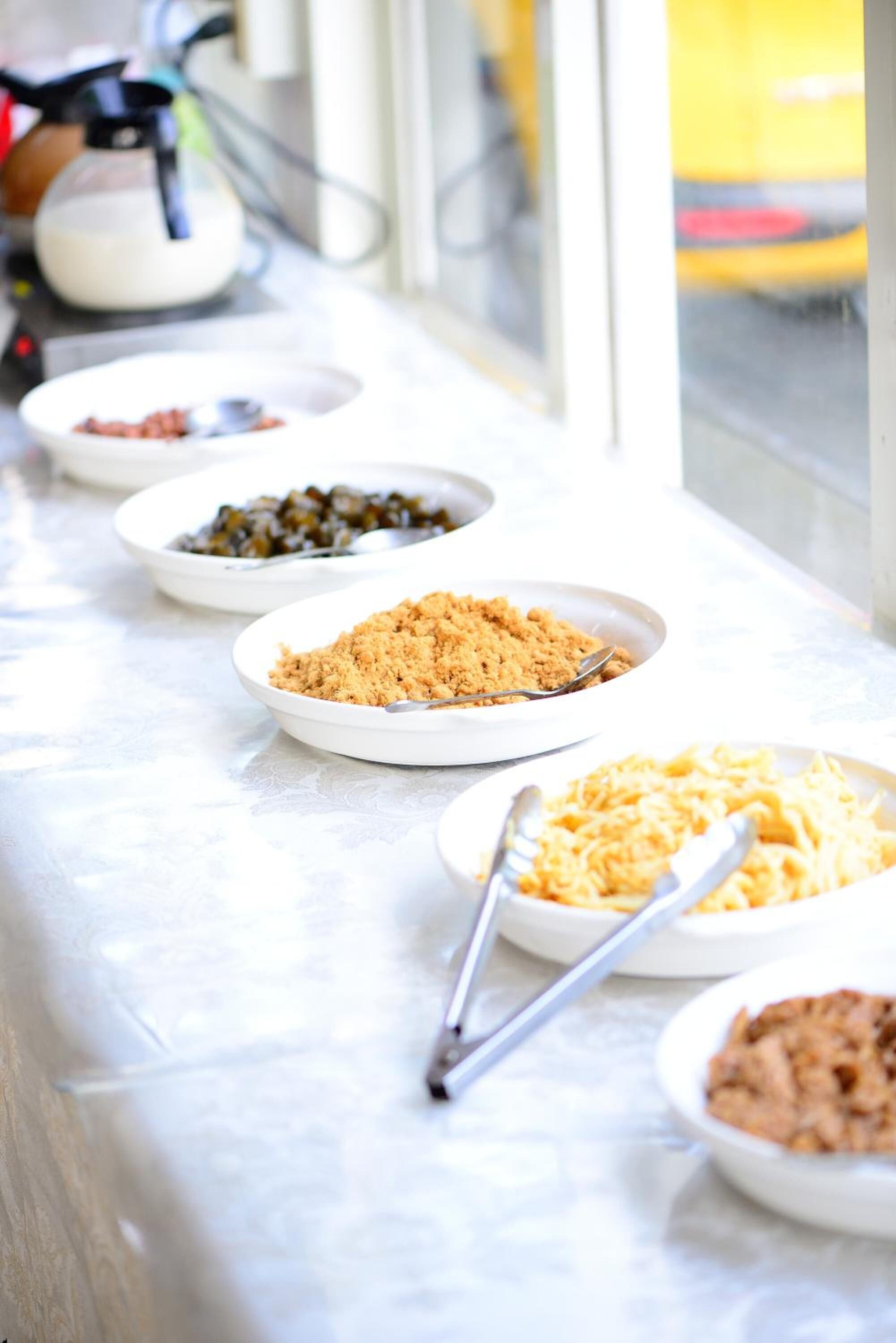 A table with various food items in bowls.
