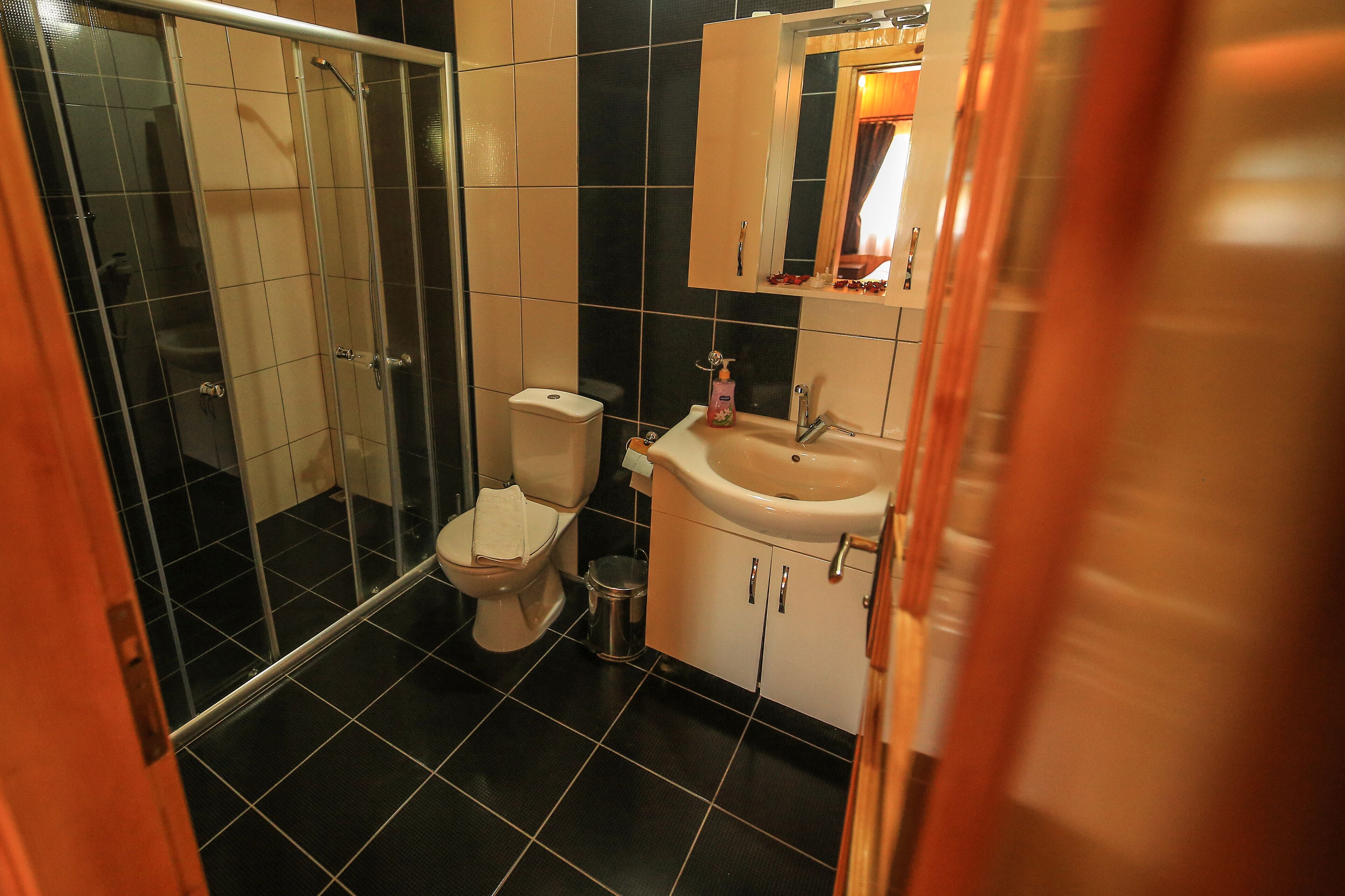 shower, hair dryer, slippers, towels