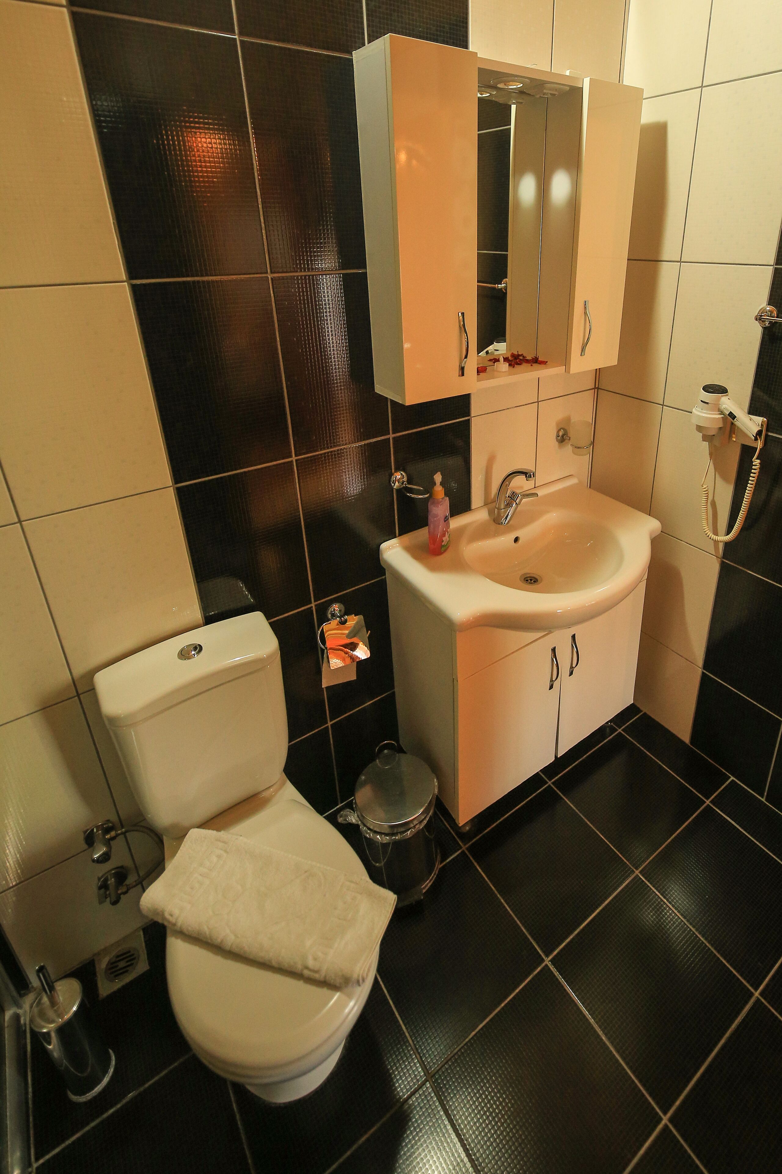 shower, hair dryer, slippers, towels