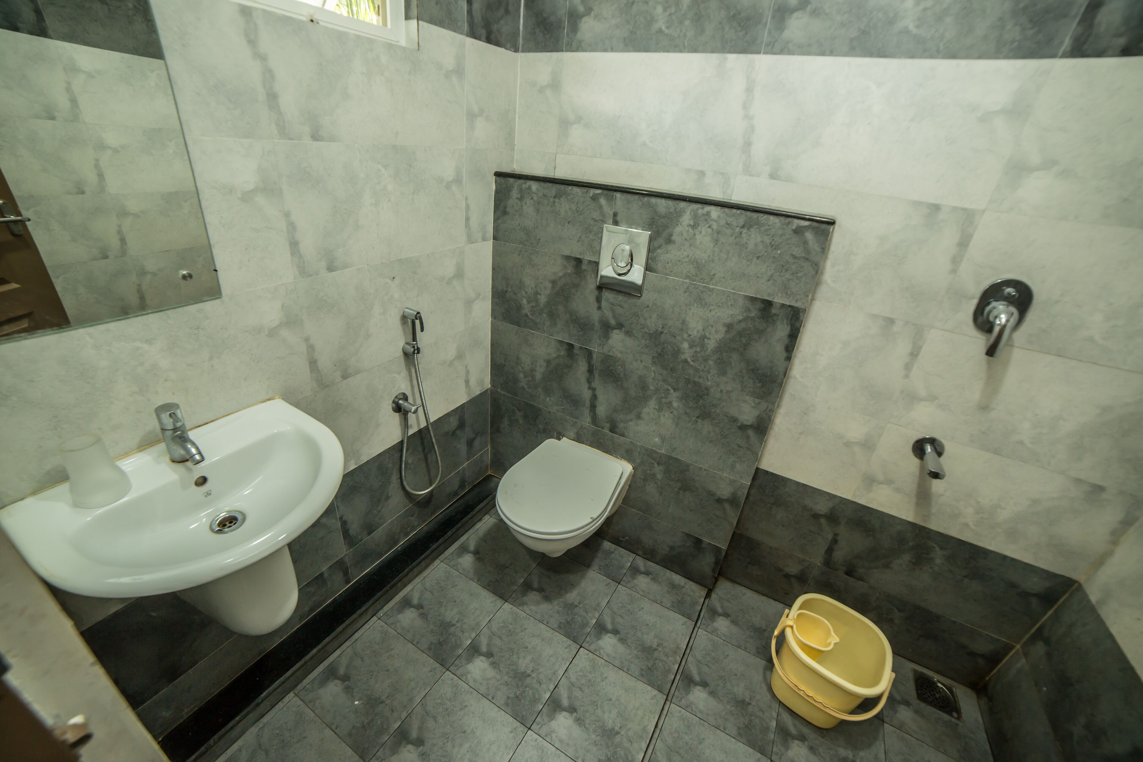 A bathroom with a sink, toilet, and shower.