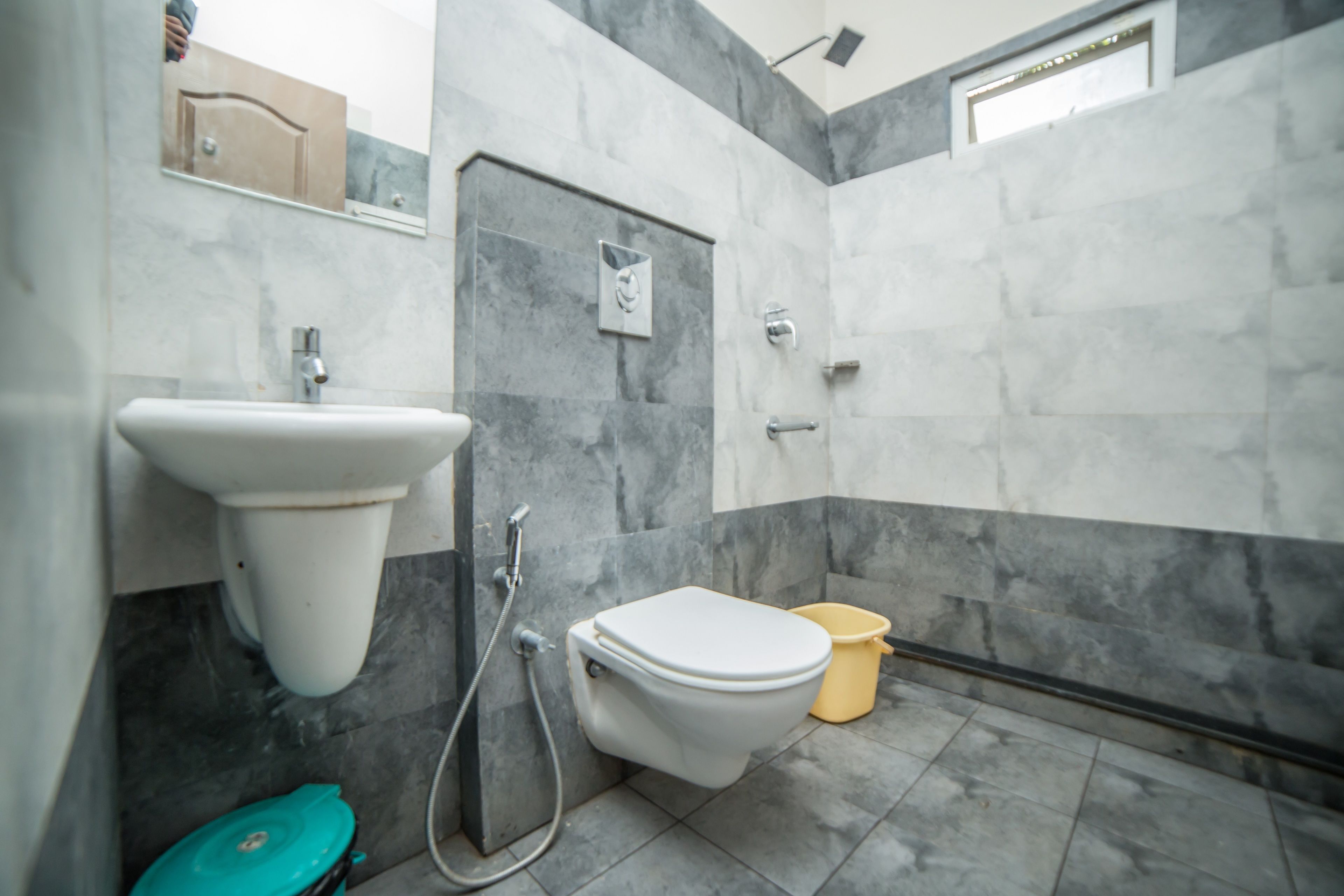 A bathroom with a white sink, a toilet, and a shower.