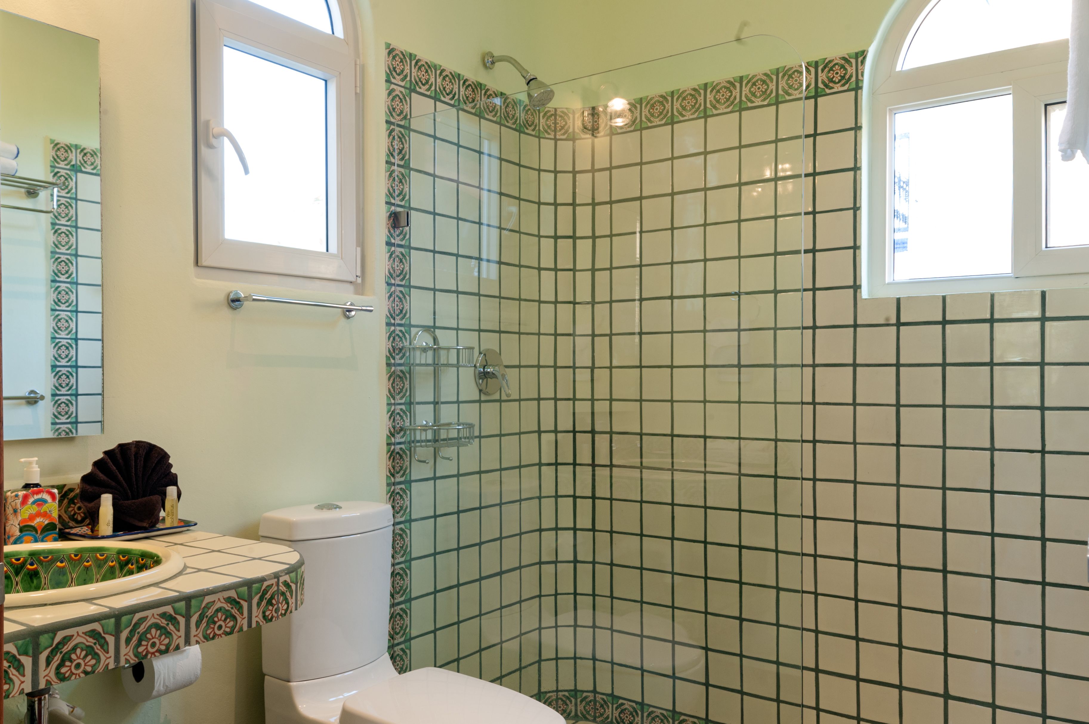 A bathroom with a toilet, sink, and shower.
