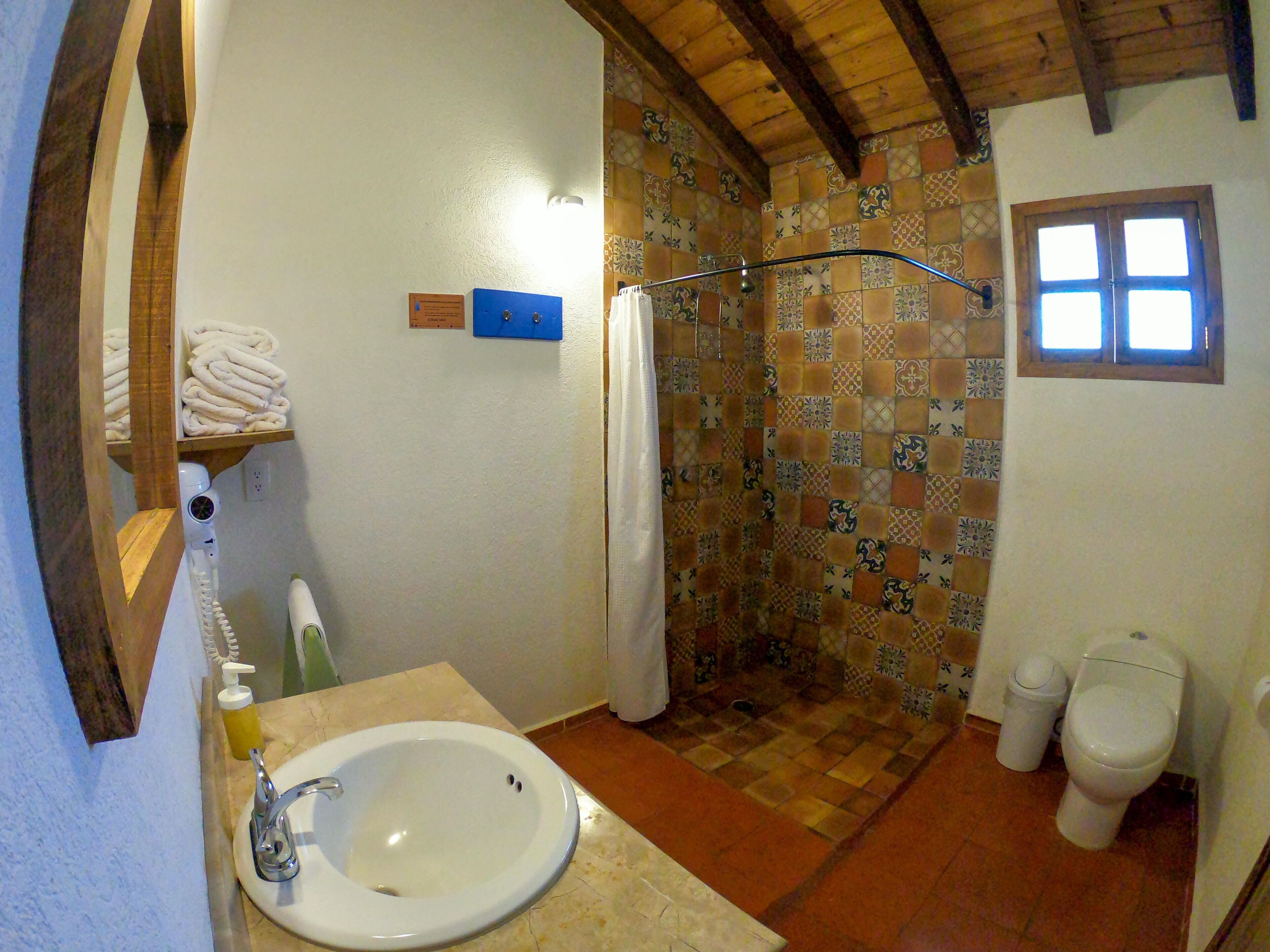 premium quadruple room, 2 queen beds, accessible, garden view | bathroom | shower, free toiletries, towels