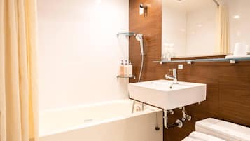 A modern bathroom with a bathtub, a sink, and a toilet.