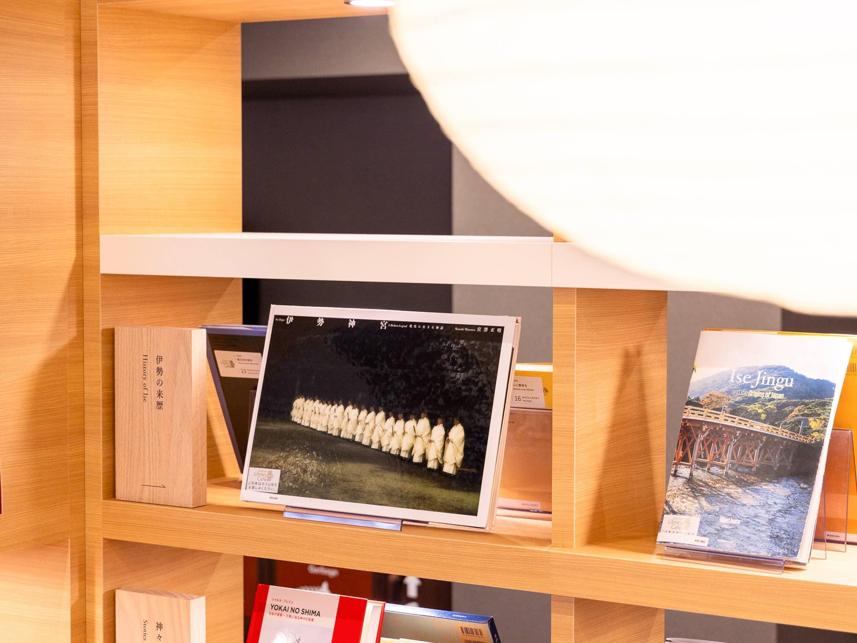 A bookshelf with books and a framed picture.