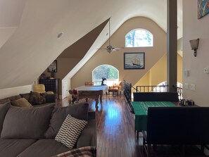 A spacious loft with high ceilings, a dining area, and a view of trees through arched windows. - Beautiful Custom Home On 3 Acre Inground Bbq  .wedding venue options DM me.  (Foresthill)