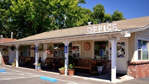 A small, single-story building with a covered porch, a sign that reads "OFFICE", and several potted plants. - Skylark Shores Resort (Lakeport)